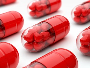 red pills filled with hearts in close-up view and depth of field